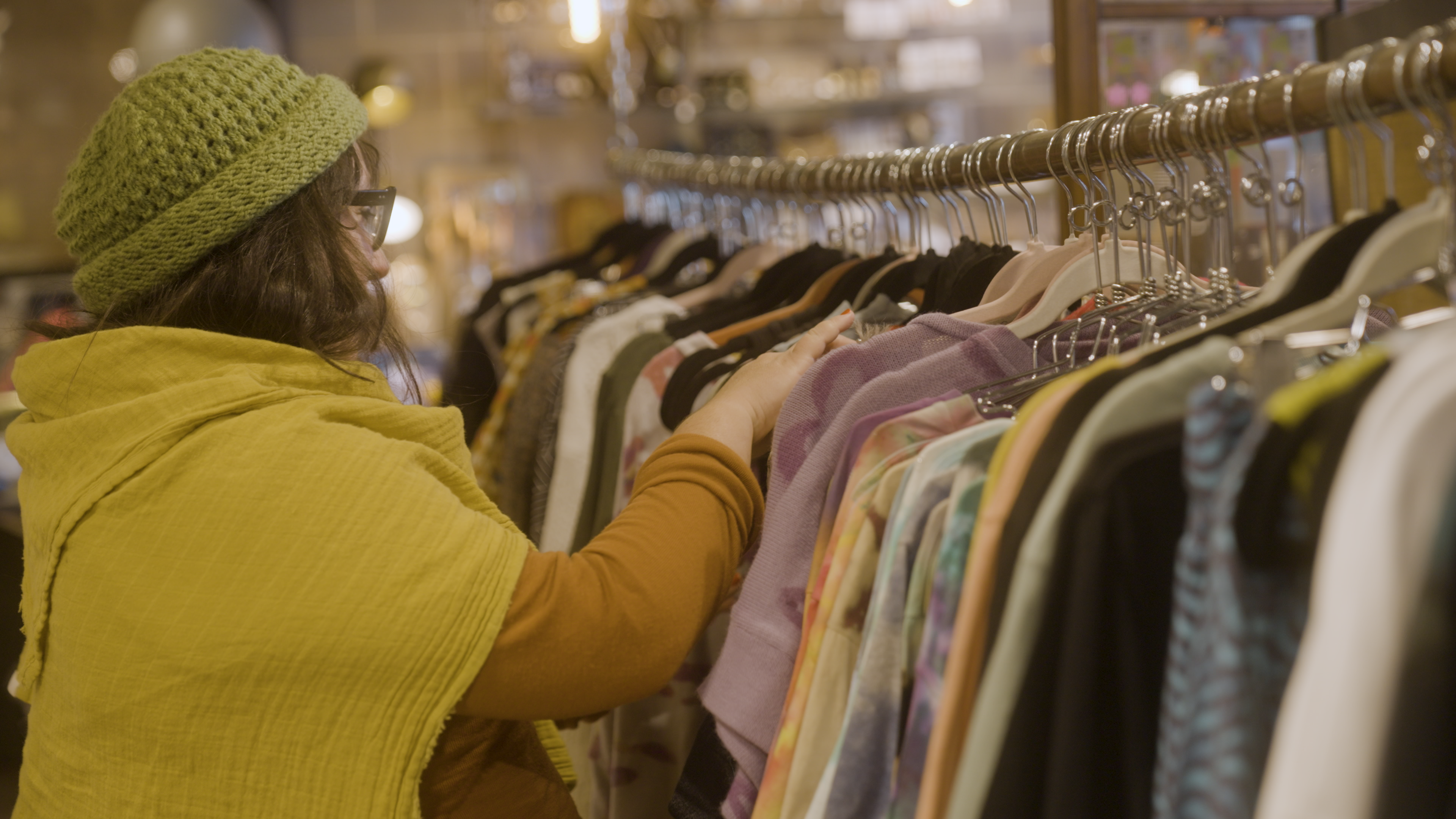 A customer is browsing clothes in the store.