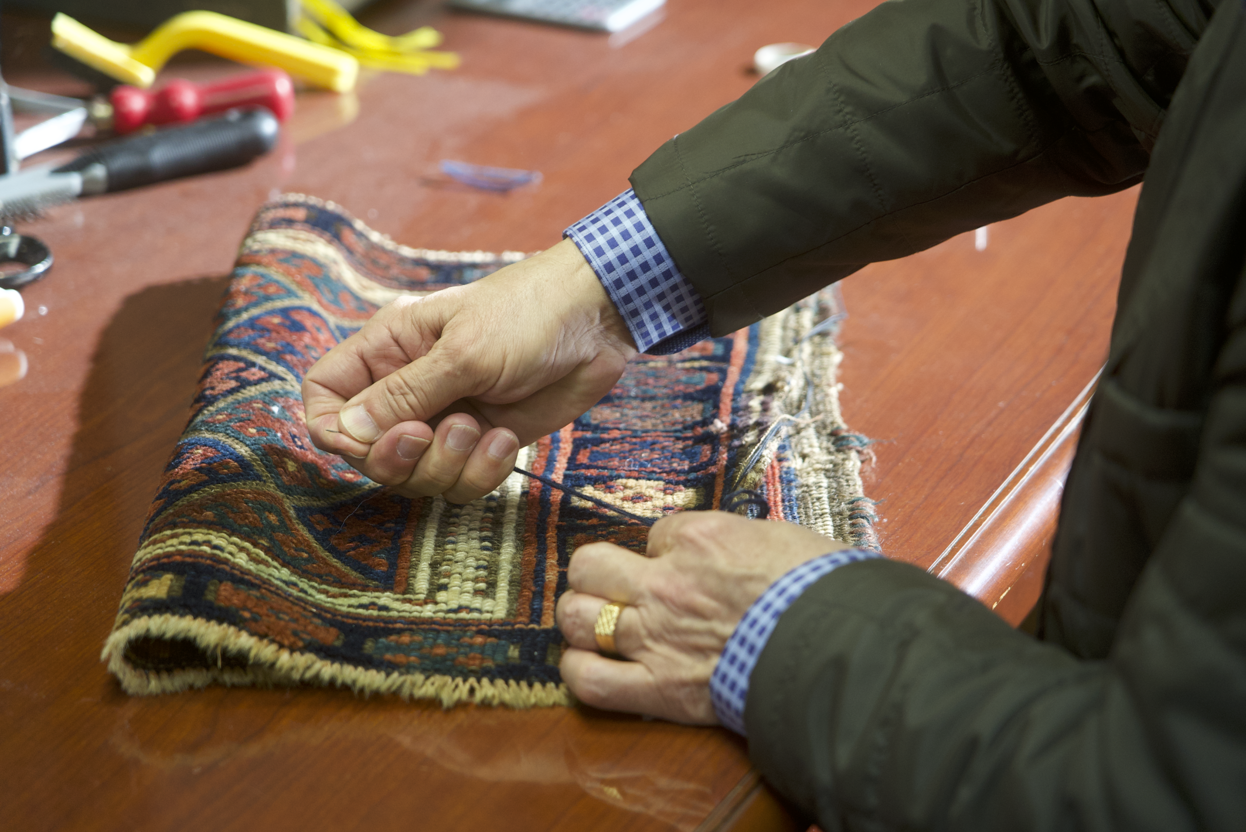 Owner sewing a rug